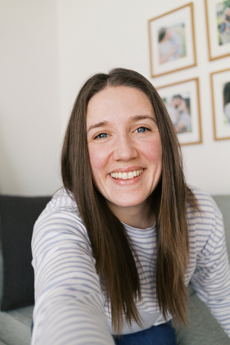 Iowa wedding photographer Bethany McNeill holding a camera