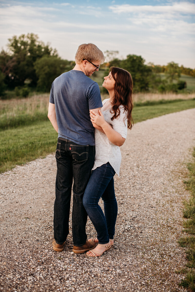 Man and woman embracing each other on a gravel road