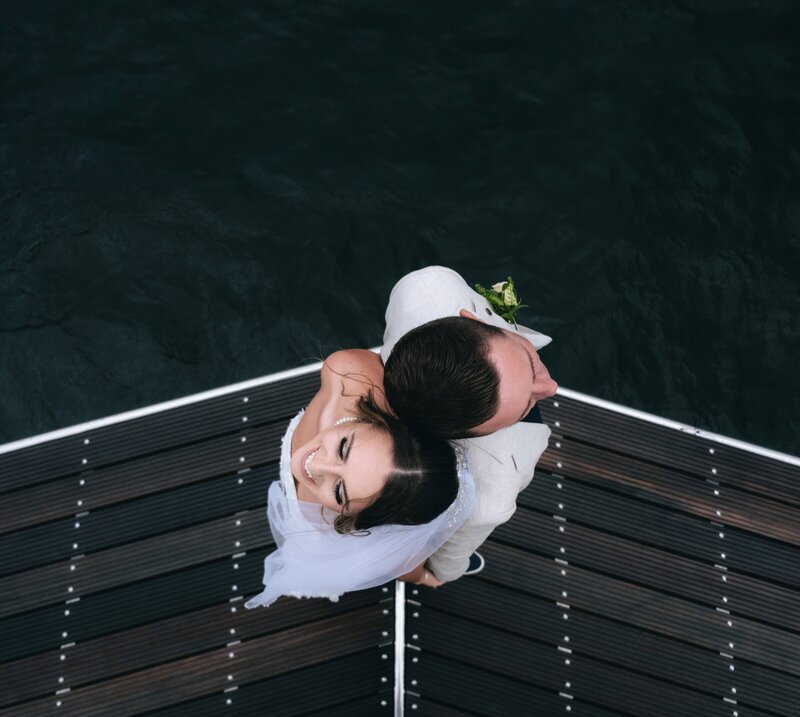 wedding couple back to back on oat stern