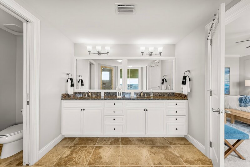 double vanity with white cabinetry and granite countertop