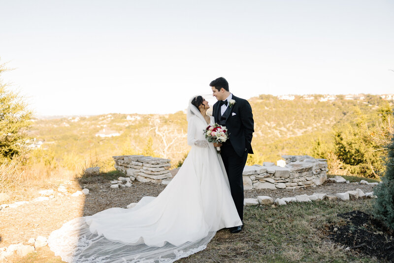 Catholic bride and groom pose for photos at Schoenstatt Shrine in Austin Texas after their nuptial Mass.