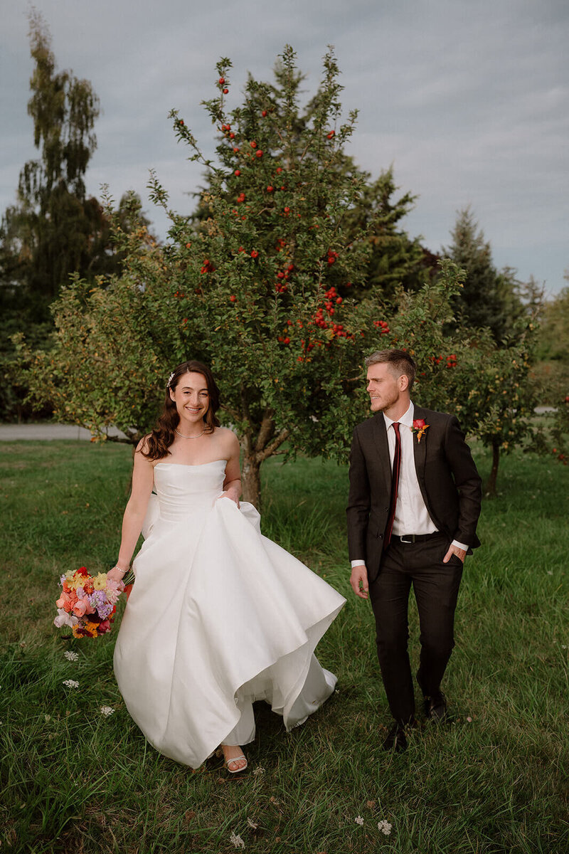bride and groom walking together at Sea Cider wedding
