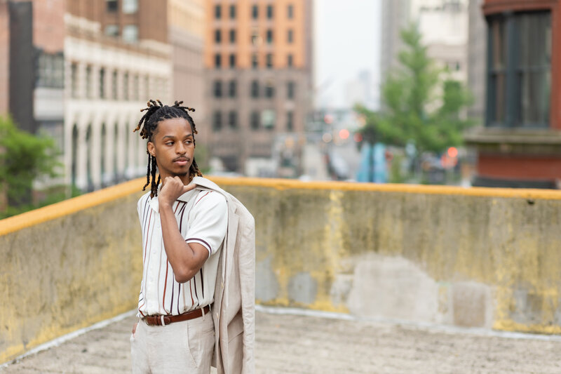 Senior Boy posing for downtown Detroit Senior photos with Savvy Shoots Photography