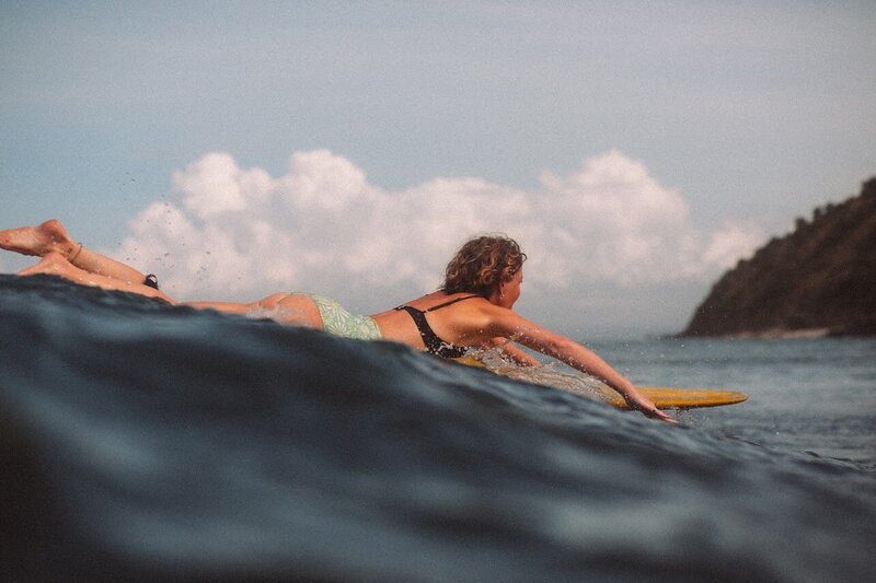 Woman surfing at Santai Retreats - longboarding retreat in Indonesia