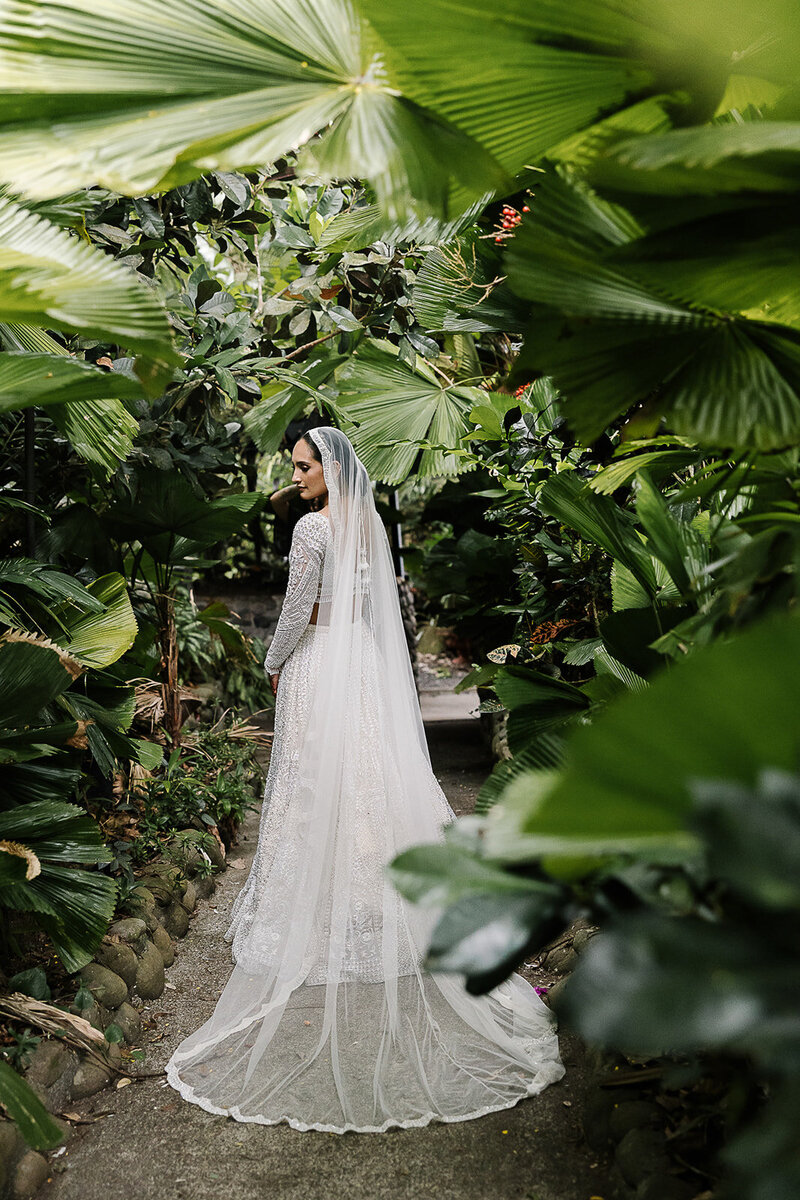 bride in long veil in jungle location