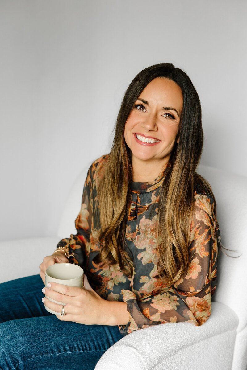 Christina smiling while holding a mug