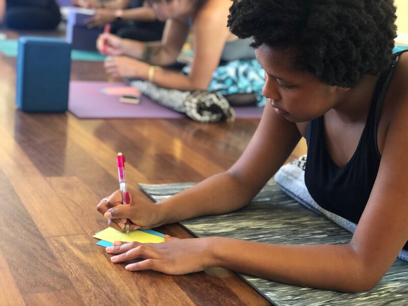 Student in quiet contemplation during Soma Yoga Institute’s premier yoga instructor training, integrating the deeper teachings of yoga