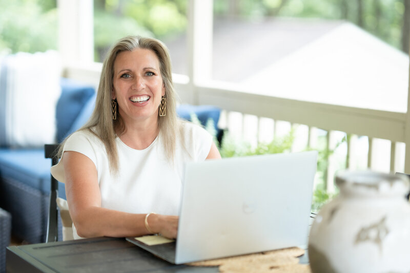 Therapist Shelby John at desk smiling confidently