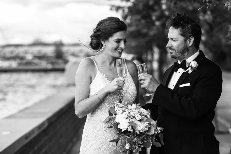 Bride and groom toast with a glass of champagne outsde the Sheraton Erie Bayfront Hotel