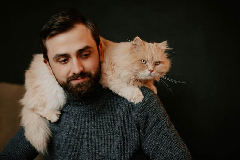 cat sitting on owner's shoulders