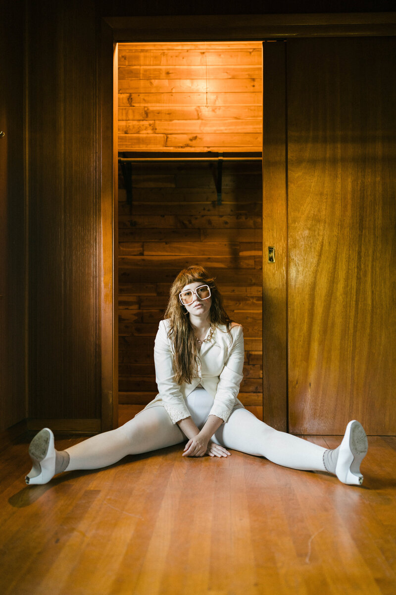 woman sitting on a blue chair in heels