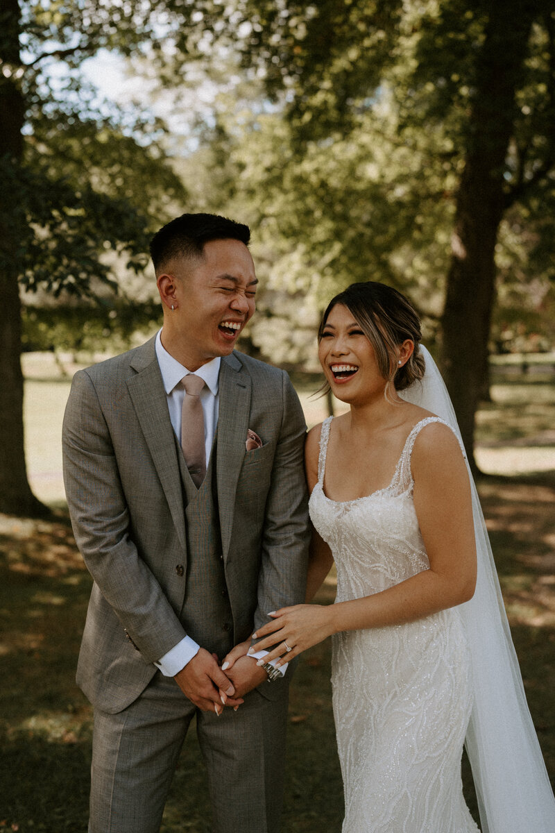 couple laughing under a tree