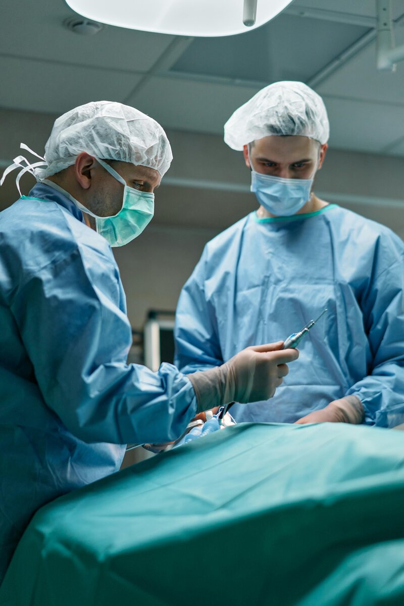 2 male surgeons with instrument