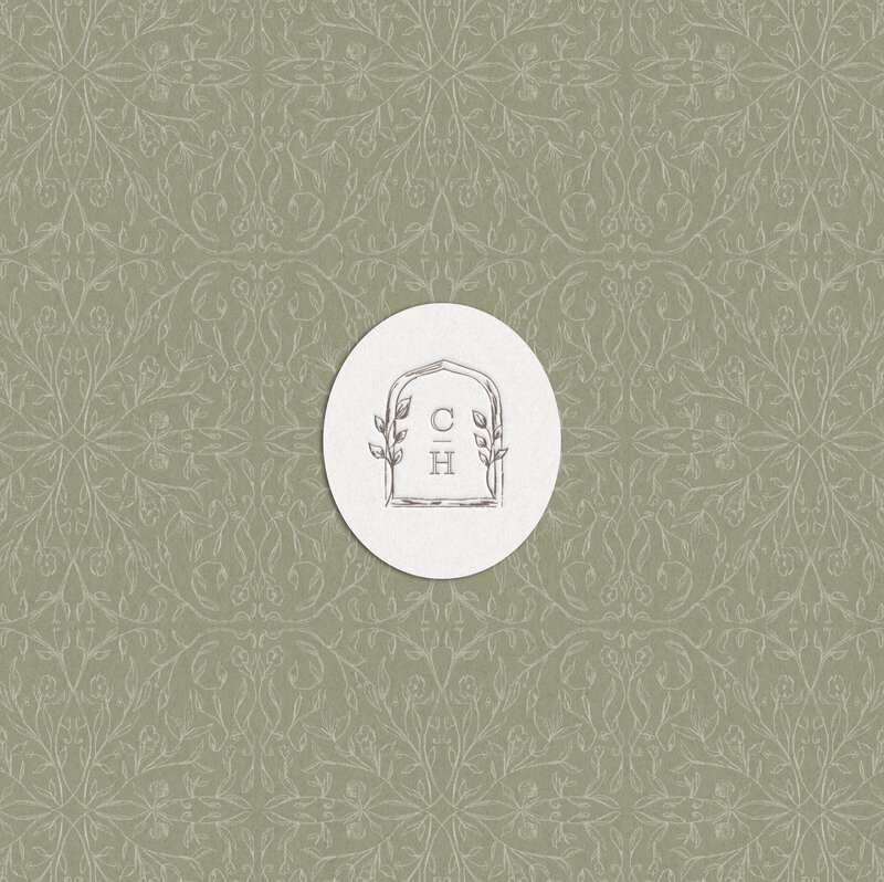 Close-up of hand-sketched Caswell House brand element on a branded tag