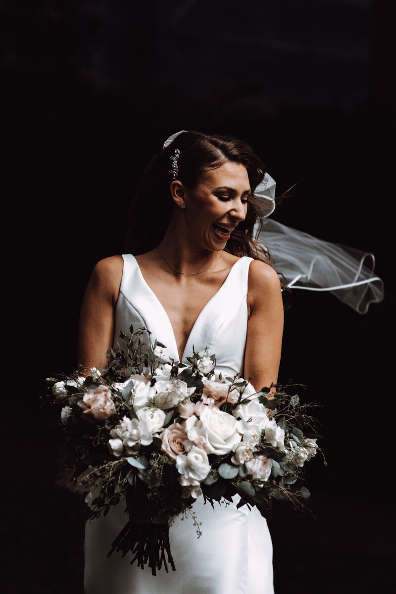 Sample image by Philadelphia wedding photographer Daring Romantics. A portrait of a joyful bride holding her bouquet.