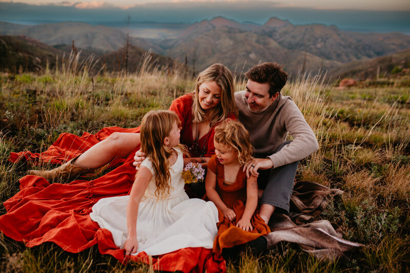 A family of 4 enjoy and laugh during a summer day in the mountain west of Fort Collins, Colorado