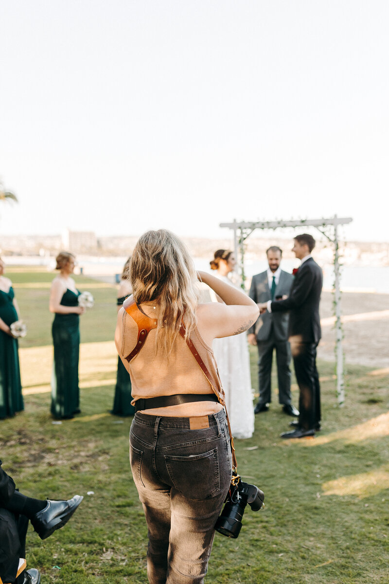 A candid photo of a wedding photographer working