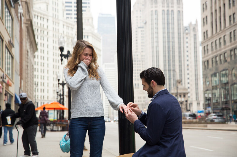 woman gasping from surprise engagement downtown chicago mag mile