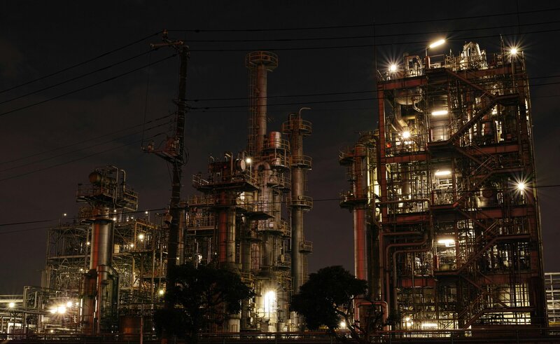 Oil and gas facility at night illustrating high-risk industry operations