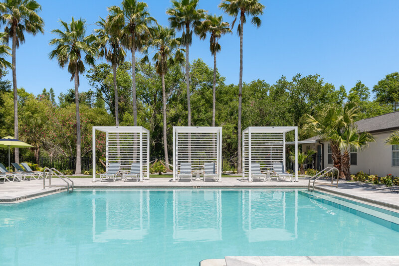 white cabanas at an apartment complex designed by Gracious Home Interiors