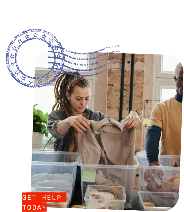 woman holding up a shirt taken from a donation bin