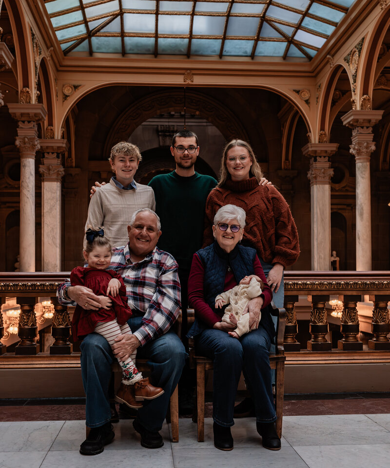 grandparents posing with their grandparents in the Indiana state house