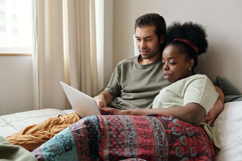 A diverse couple, feeling more connected after a  Gottman Method Couples Therapy Session.