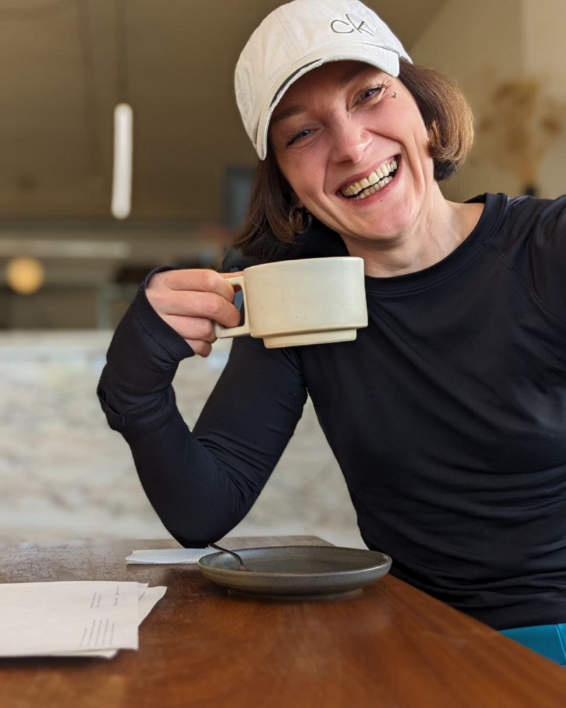 Ulrike Storch smiling with coffee cup in hand _aboutpage