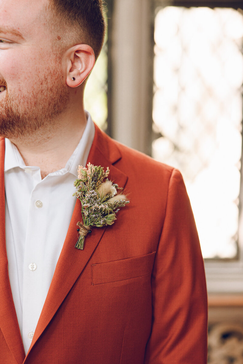 One of the grooms gets dressed for his wedding at the Morton Arboretum in Lisle Illinois