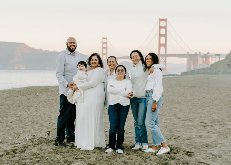 family of 7 poses in front of golden gate bridge