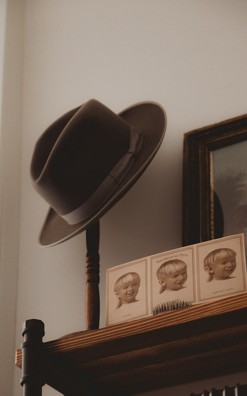 a detail shot of a hat on a shelf in a vintage shop