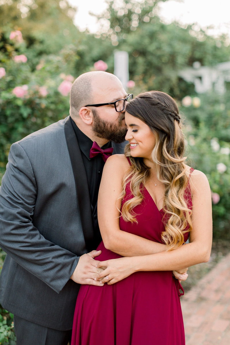 Future Groom kisses his Bride's forehead during engagement session