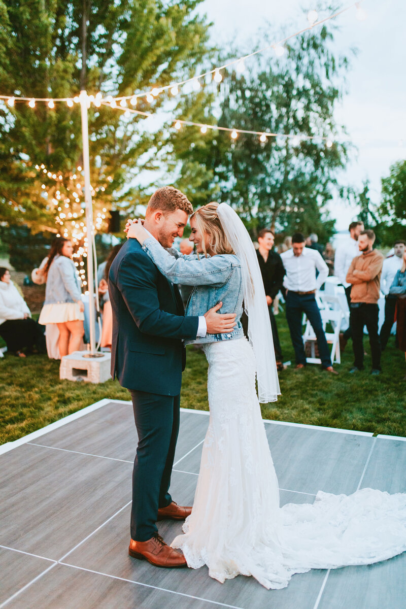A couples first dance outside among their guests.