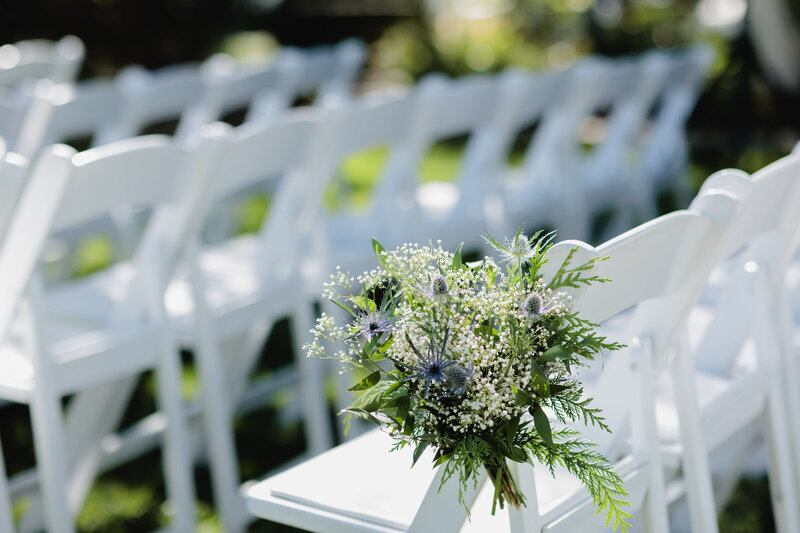 Delicate flowers line the wedding aisle