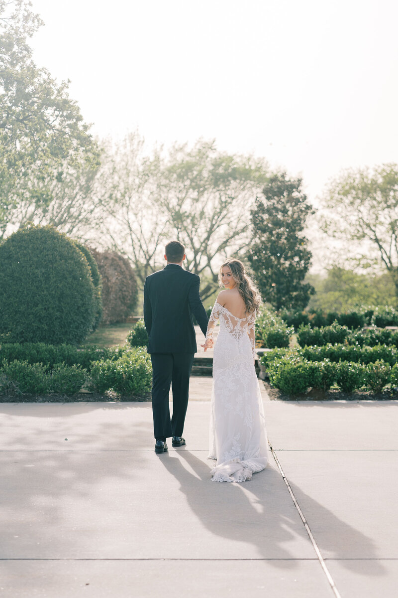 bride-groom-holding-hands-outdoor-romantic-wedding