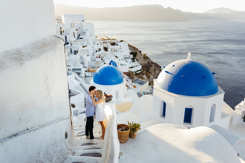 Couple eloping in Santorini against the blue and white churches