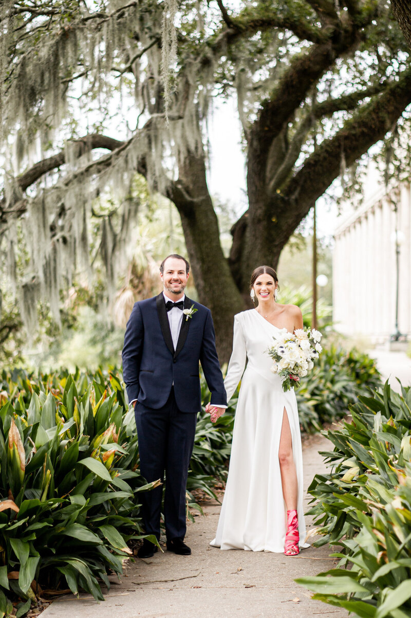 bride and groom standing in botanical garden