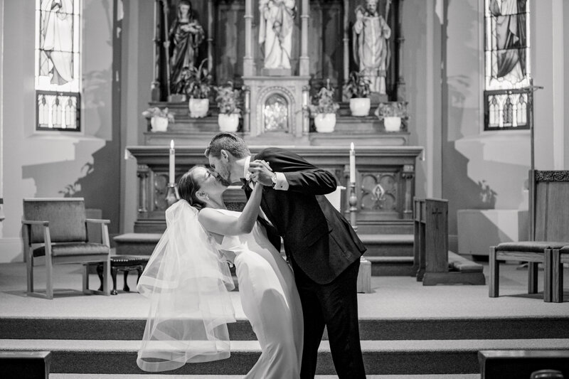 Bride and groom first kiss during ceremony at their church