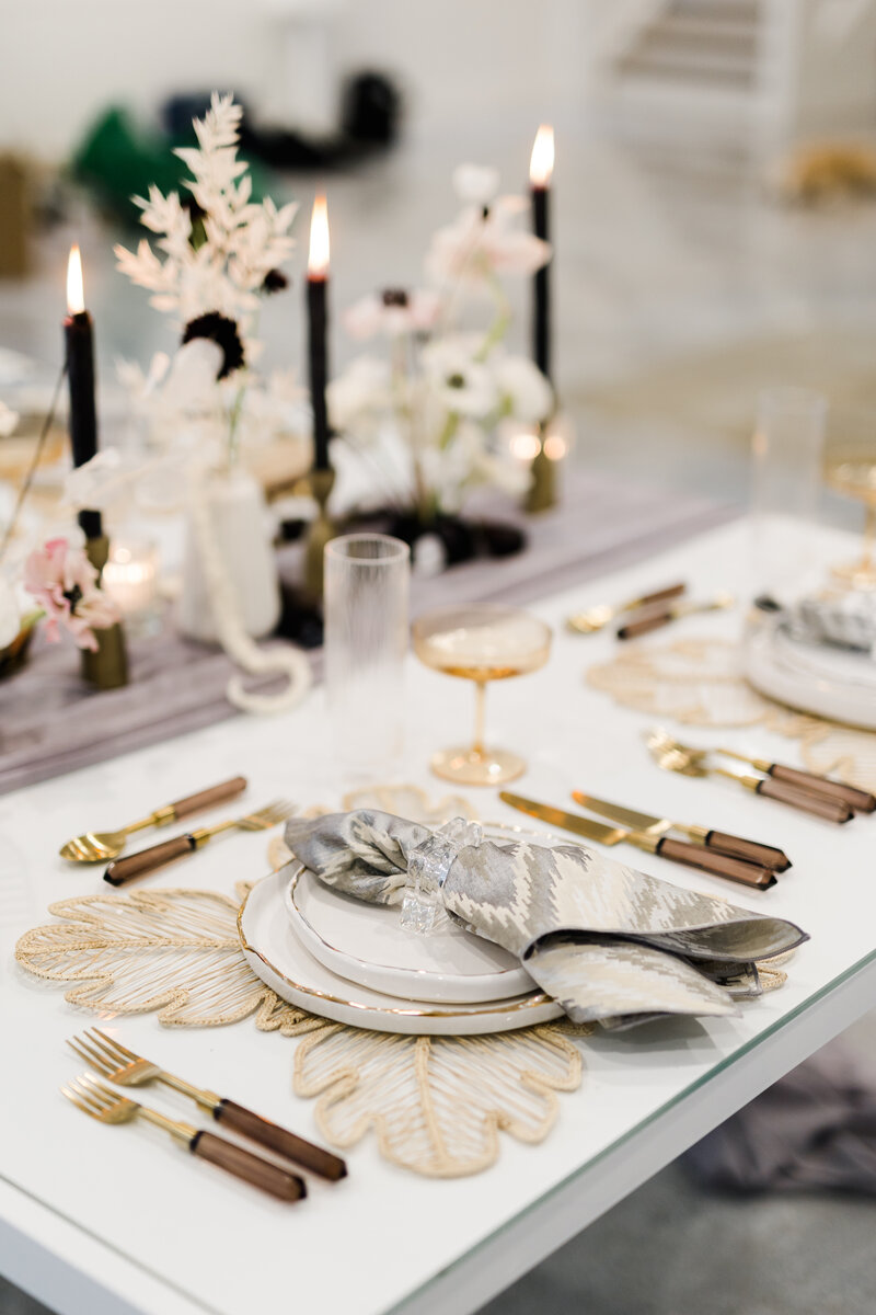 modern neutral toned tablescape with taupe and white aesthetics and florals with black taper candles
