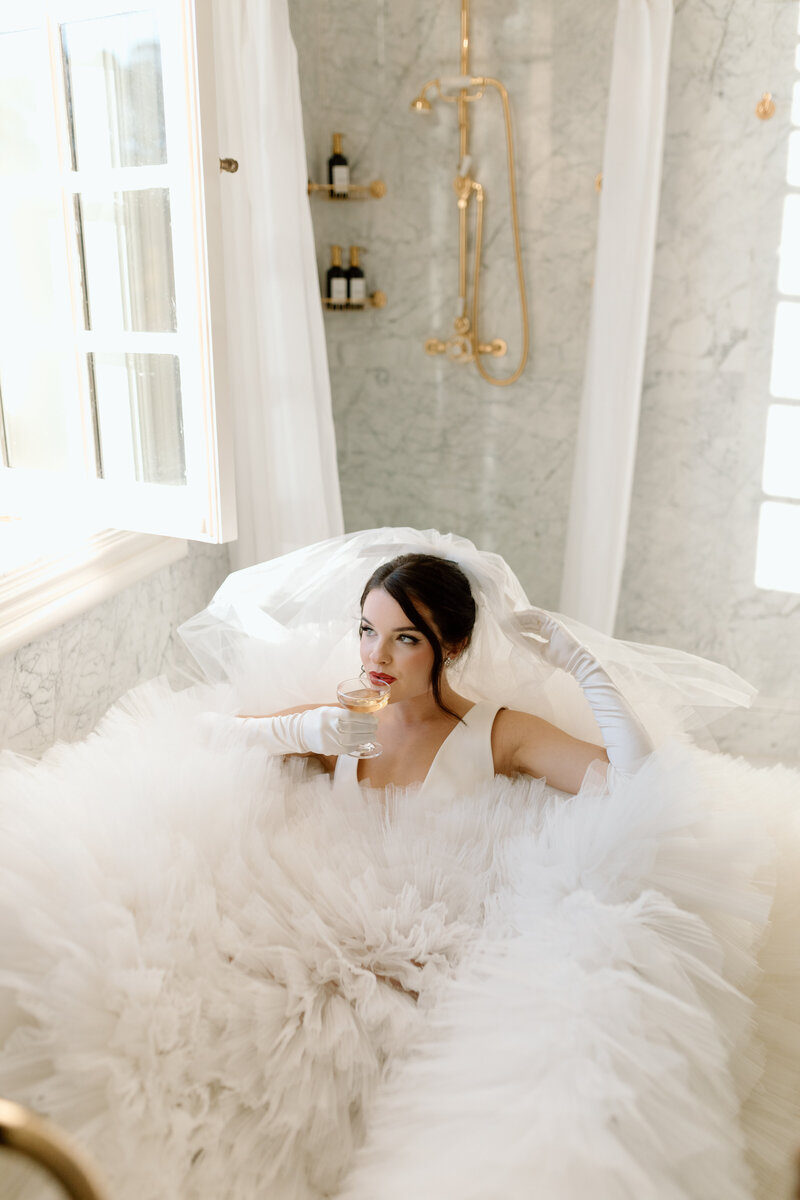 Bride in bubble dress in a bathtub