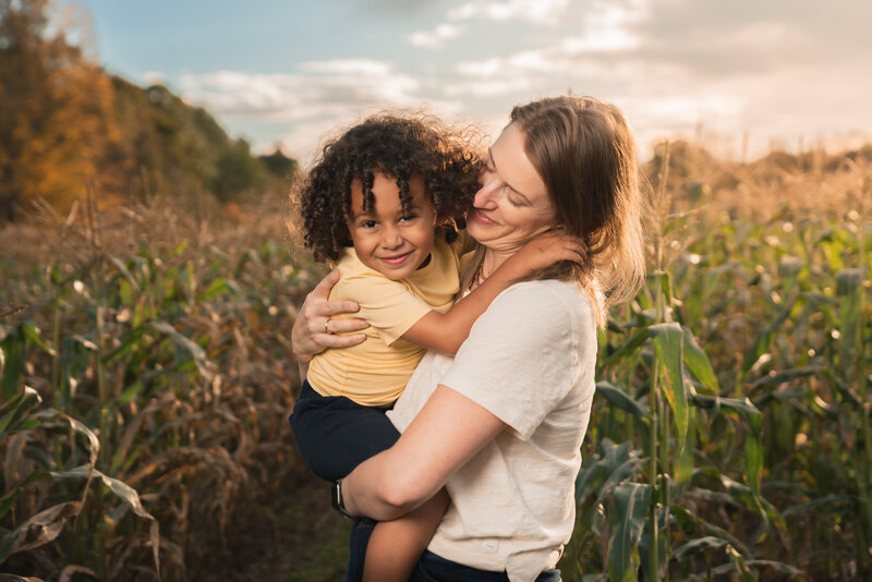 boston family photo of mom with son in front of corn
