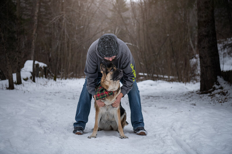 A German Shepherd is looking at Mike from Paddle Paws LLC. Work by Duluth-based pet photographer Joanna of Paddle Paws Photography.