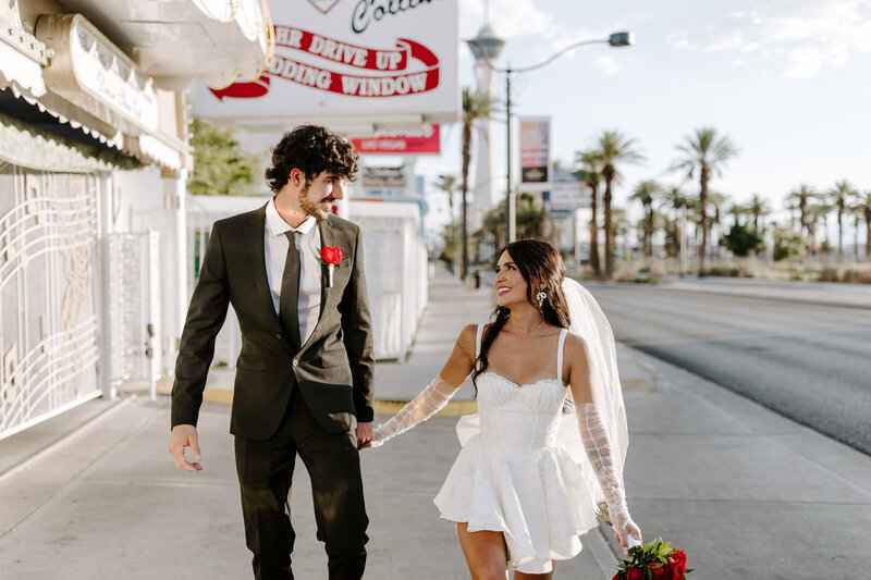 Two lovers hold hands on their elopement day at A Little White Wedding Chapel.