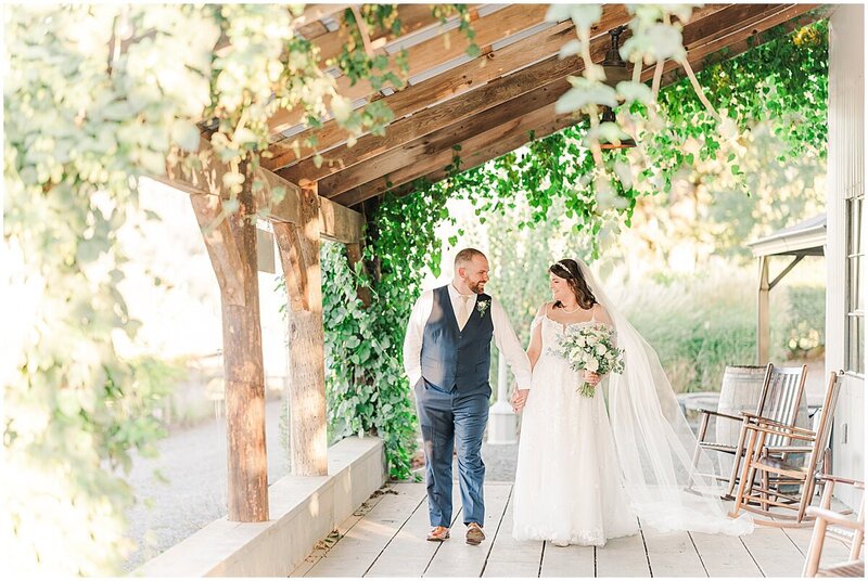 Wedding photo of bride and groom walking together on porch Portland Oregon wedding