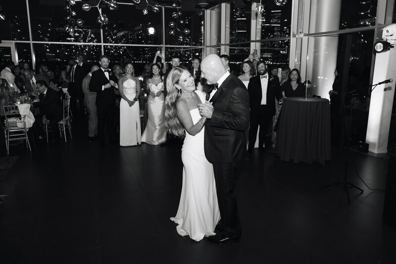 Candid black and white street wedding scene with Glenn and Laura, capturing raw moments of celebration.