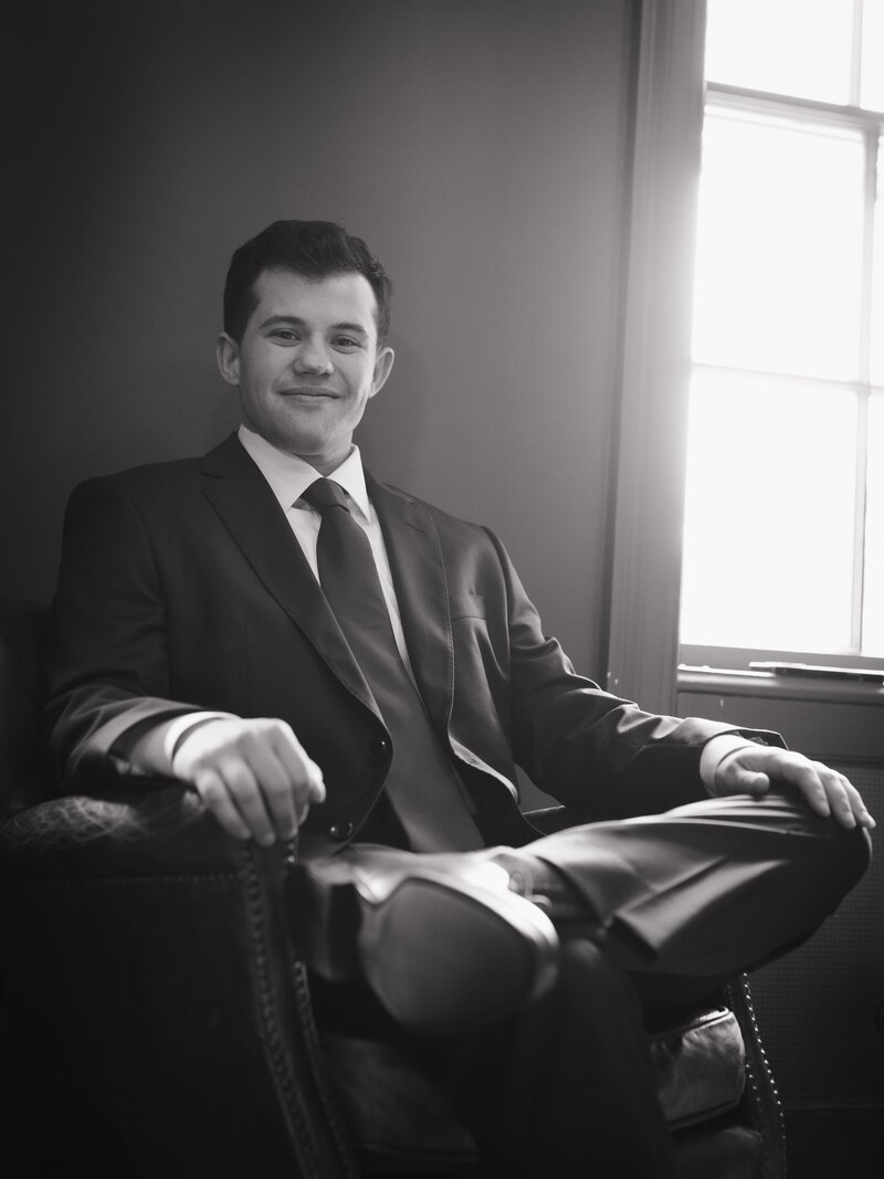 groom posing before walking down the aisle to get married