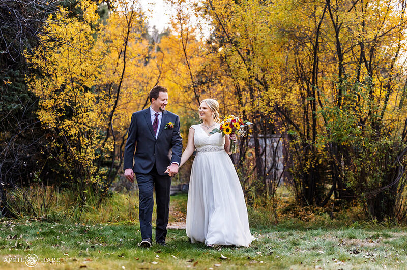 Couple Walk on the Grassy Lawn During Fall at Romantic Riversong Inn in Estes Park CO