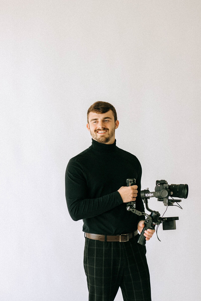 man holds video camera