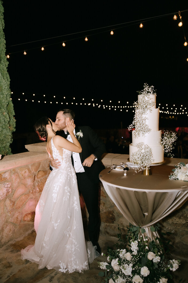 bride and groom kissing under veil at bella collina wedding florida​