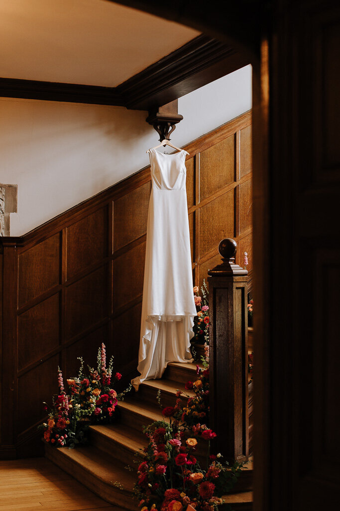 Minimalist wedding dress on display inside Salt House with natural light pouring through the windows